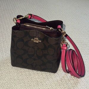 Coach monogram mini bucket bag with pink leather strap